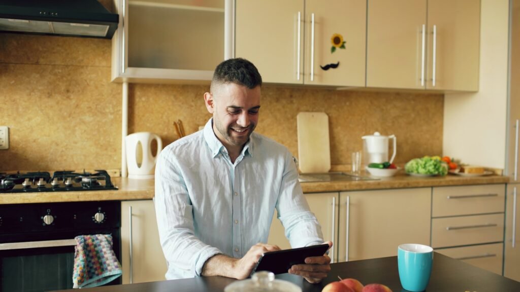 A private chef using a tablet in a modern kitchen