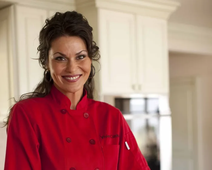 Private chef presenting a platter of appetizers in a home kitchen