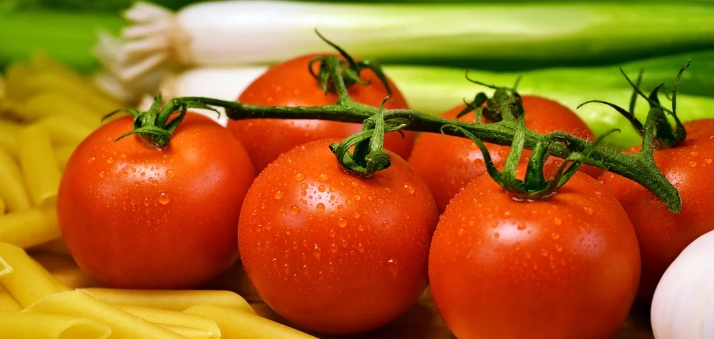 Italian pantry ingredients with vine tomatoes and pasta